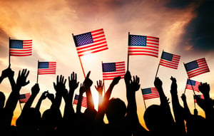 group-people-waving-american-flags-back-lit