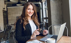 widely-smiling-businesswoman-working-laptop-sitting-cafe-1